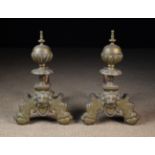 A Pair of Brass Andirons with gadrooned ball finials above scrolling bases centred by lion face