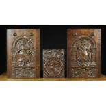 A Pair of 17th Century Arcaded Oak Panels carved with winged figures beneath gadrooned arches and