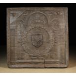 A Large 16th Century Cast Iron Fire Back richly decorated with an armorial shield to the centre