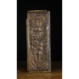 A Delightful Scottish Carved Oak Panel depicting a piper playing bagpipe with single drone,