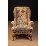 A Late 19th/Early 20th Century Queen Anne Style Wing Armchair.