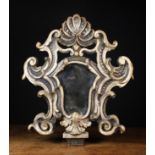 A Late 17th Century Venetian Mirror in a boldly carved, painted and partially gilded frame,