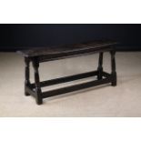 A Long 17th Century Joint Stool with residual black paintwork.