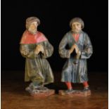 A Pair of 16th Century Polychromed Oak Relief Carvings of shackled men; their hands held in prayer,