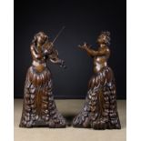 A Pair of Large Baroque Relief Carved Oak 'Opera' Figures: Both wearing a flowing skirt of pendant