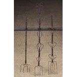 Three 19th Century Wirework Toasting Forks; each having four prongs on a decorative handle,