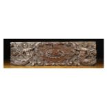A Relief Carved Oak Panel centred by a leaping dog in a cartouche flanked by winged caryatids,