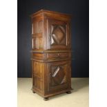 A 17th/Early 18th Century Franco-Flemish Two Part Cupboard having an upper and lower single-doored