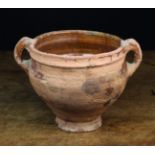 A 16th Century Terracotta Cooking Pot with glazed interior and loop handles;
