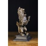 A Finely Cast Bronze Patinated Heraldic Lion Sejant Erect sat upon a square ebonised wooden plinth