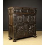 A 17th Century Oak Enclosed Chest of Drawers richly decorated with geometric cushion front