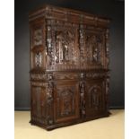 An Imposing 17th Century Flemish Two Part Oak Cupboard decorated with extensive carving.