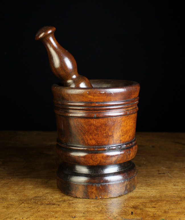 A 17th Century Turned Lignum Vitae Pestle and Mortar. The pestle 10 in (25.