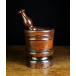 A 17th Century Turned Lignum Vitae Pestle and Mortar. The pestle 10 in (25.
