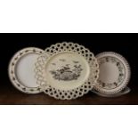 Four Late 18th Century Creamware Plates with sepia decoration: An oval Wedgwood plate with a