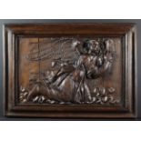 A 17th Century Relief Carved Oak Panel in a moulded frame, depicting a winged angel with curly hair,
