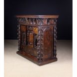 A Fabulous Italian Burr Walnut 'Bambocci' Cabinet richly carved with elaborate decoration