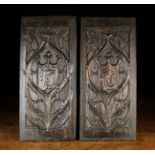 A Pair of Oak Carved Gothic Tracery Panels centred by fleur-de-lis crested shields emblazoned with