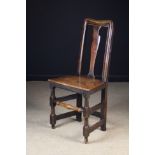 A Queen Anne Joined Oak Side Chair with moulded top rail and uprights framing a shaped central