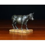 A Small Bronze Figure of a Cow mounted on a brêche marble socle, 4¾ in (12 cm) high, 6½ in (16.
