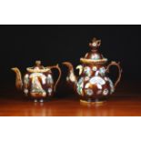 Two Victorian Barge-ware Teapots sprigged with relief moulded flowers and foliage daubed with green,