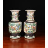 A Pair of Oriental 'Famille Verte' Crackle-glazed Vases enamelled with figural landscapes and