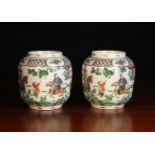 A Pair of Chinese Jars with open tops decorated with polychrome enamels with figures in landscape