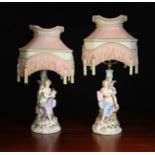 A Pair of Continental Porcelain Figural Occasional Lamps modelled as classical muses' one with a