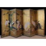 A 19th Century Japanese Six-fold Screen hand-painted with wading storks amidst rockwork and bamboo,