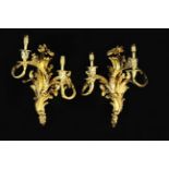 A Pair of Louis XV Style Gilt Metal Wall Sconces cast with sprays of crested acanthus and having