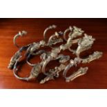 Six Pairs of 19th Century French Gilt Metal Curtain Tie Backs: One pair with pierced Rococo