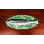 A Rare Majolica Fish Dish modelled as a long oval brown-glazed basket with a pike lain on a bed of
