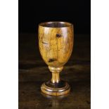 A 19th Century Oak Goblet with turned knop to base of bowl and short stem over a circular foot with