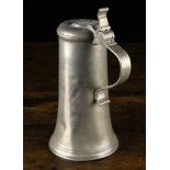 An Antique Pewter Flagon having a flared body with hinged lid, engraved with initials .L.B.T.
