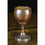 A 19th Century Goblet or Loving Cup with a plain polished coconut bowl set on a turned oak stem and
