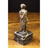 A Medieval Bronze Figure of a Pilgrim, mounted in a black & white veined marble plinth,