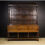 A Late 18th Century Oak Dresser with Rack. The rack having planked back shelves with iron cup hooks.
