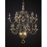 A 19th Century Silver Patinated Brass Chandelier with twelve scrolling candle arms set in two tiers