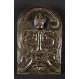 A Fine 16th Century English Oak Arch-topped Panel carved in relief with the head of a moustached