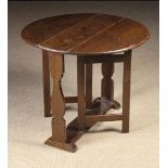 A Small 18th Century Oak Gate-leg Table on silhouette cut baluster plank supports terminating with