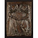 A Late 15th/Early 16th Century Oak Panel carved in relief with a pair of winged angels holding