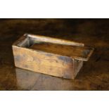A Small Dug-out Elm Box of rectangular form with sliding lid, 2 in (5 cm) high, 5¼ in (13 cm) long,