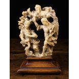 A 16th Century Alabaster Carving of The Annunciation mounted on a moulded mahogany plinth,