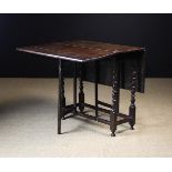A Small Late 17th Century Oak Gateleg Table. The rectangular top with two drop flaps on plain gates.