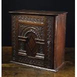 A Fine Charles I Carved Oak Mural Spice Cabinet.