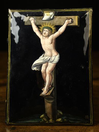 A 17th Century Limoges Enamelled Plaque depicting Christ on the Cross against a dark blue ground,