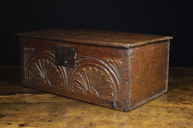 A Small Late 17th/Early 18th Century Boarded Oak Box enriched with lunette carving incorporating