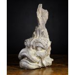 A 17th Century Carved Oak Corbel boldly carved in the form of a dolphin, 18½ in (47 cm) high,