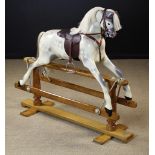 A Painted Dappled Grey Wooden Rocking Horse with horse hair mane and leather tack,