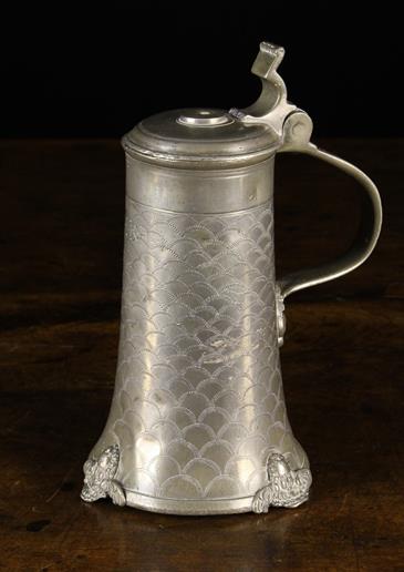 An Early 18th Century Pewter Tankard with hinged lid.